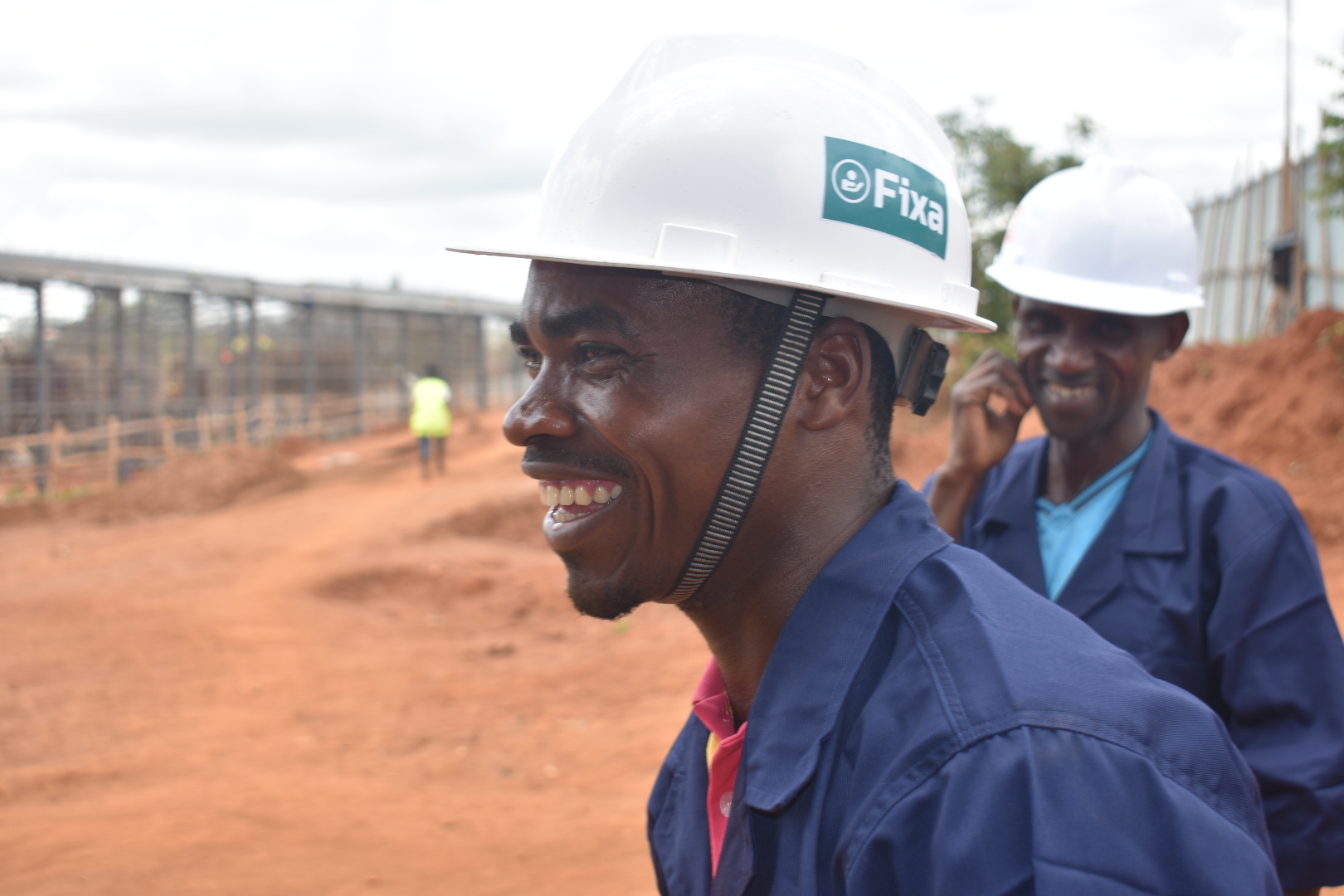 Workers in Fixa hardhats at a job site