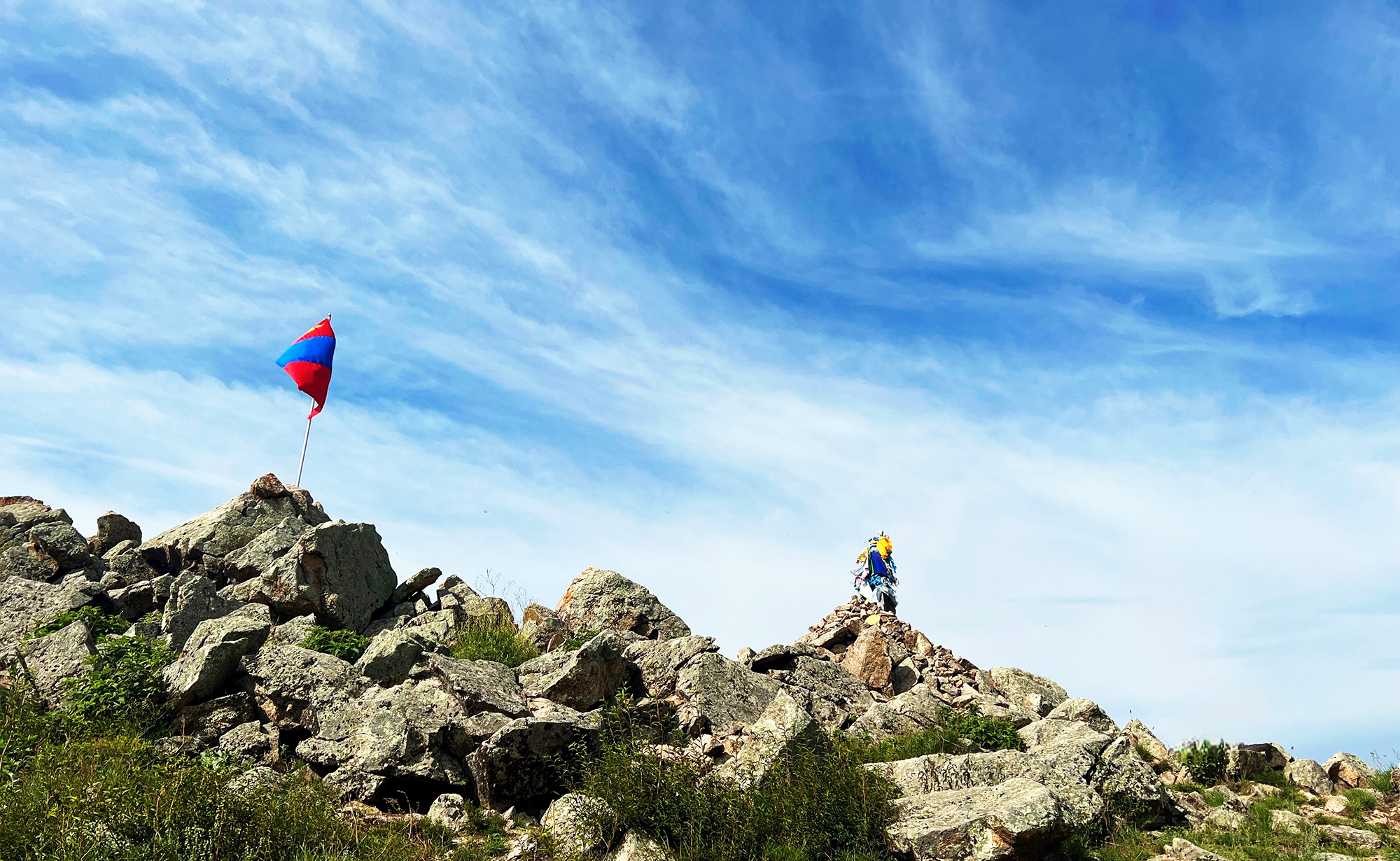 Ovoos, piles of stones, are often found at the top of sacred mountains and serve as sites for the worship of heavenly gods in Mongolian Shamanism.