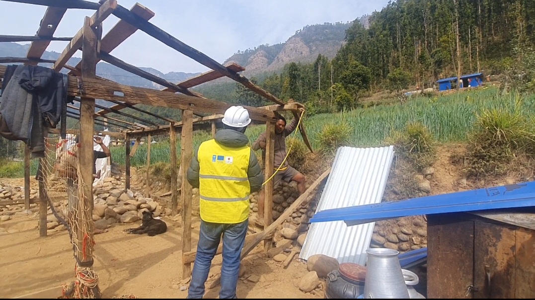 an engineer helping a person rebuild his house