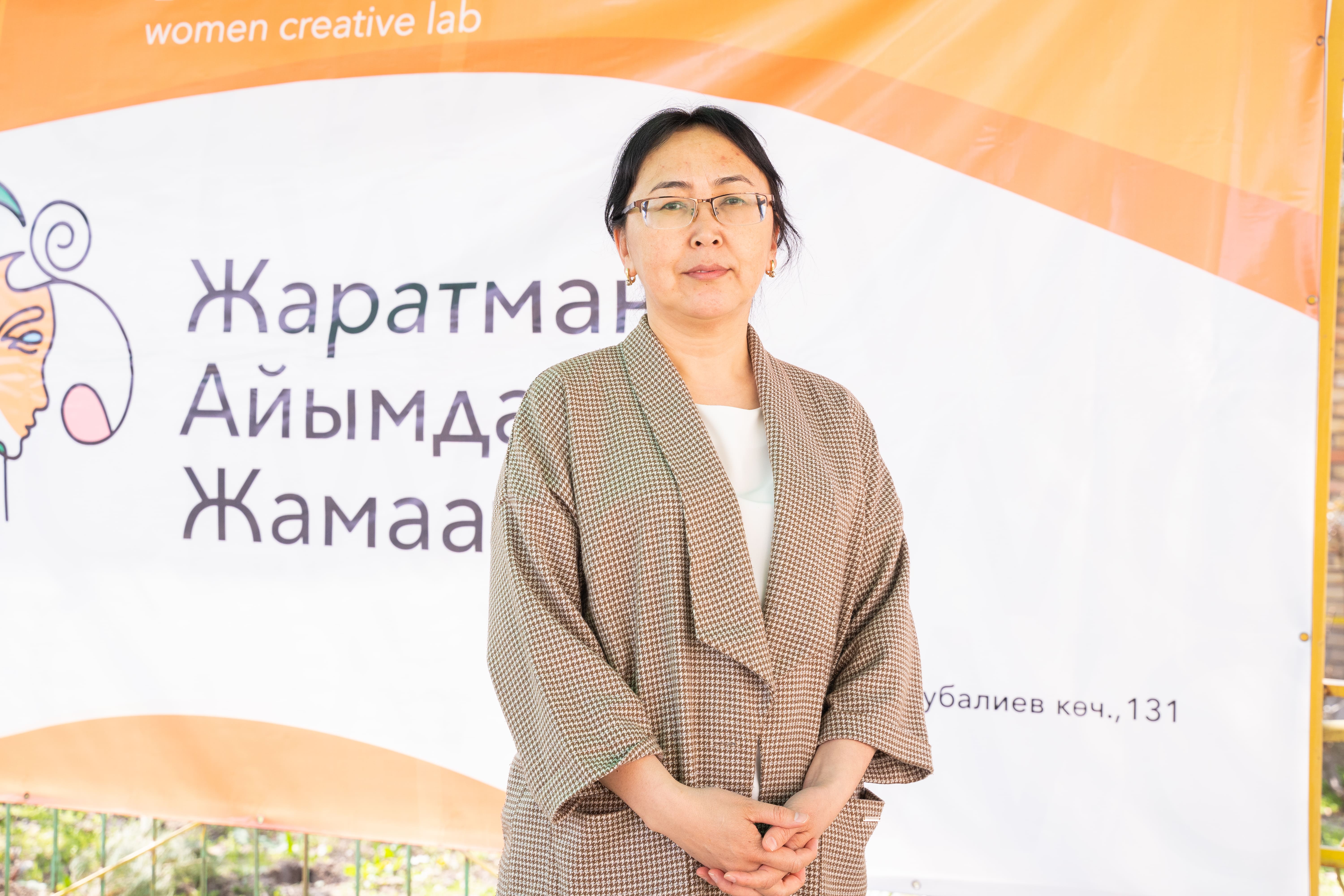 a woman holding a sign posing for the camera