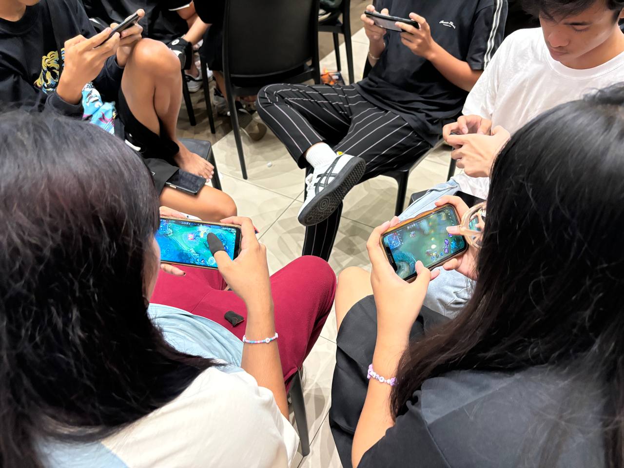 a group of people looking at a phone