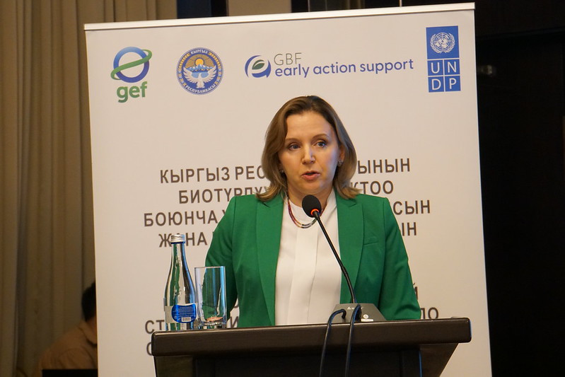 a person standing in front of a mic and giving her speech