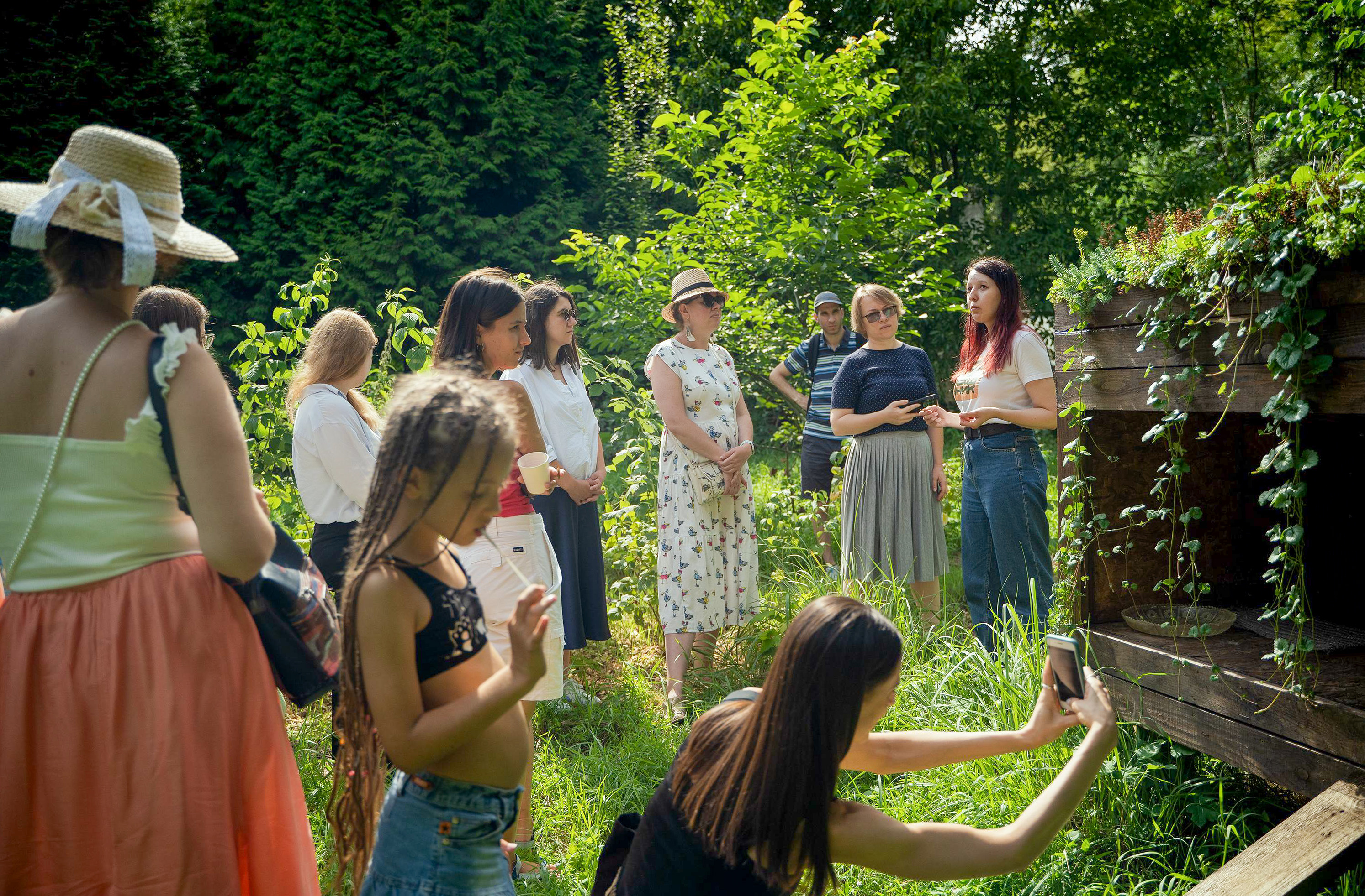 a group of people standing in a garden