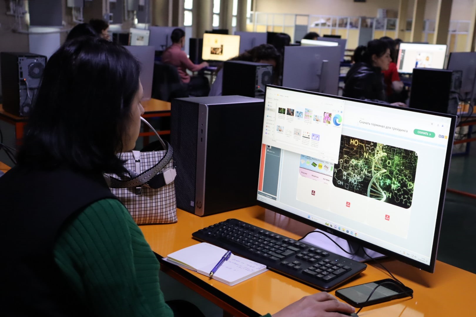 a group of people sitting at a desk in front of a computer