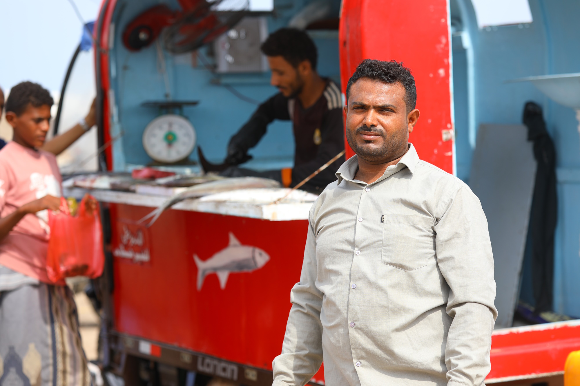 a man standing next to a truck