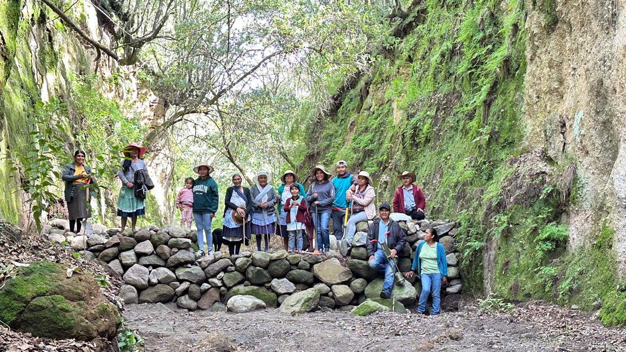 a group of people standing on a rock