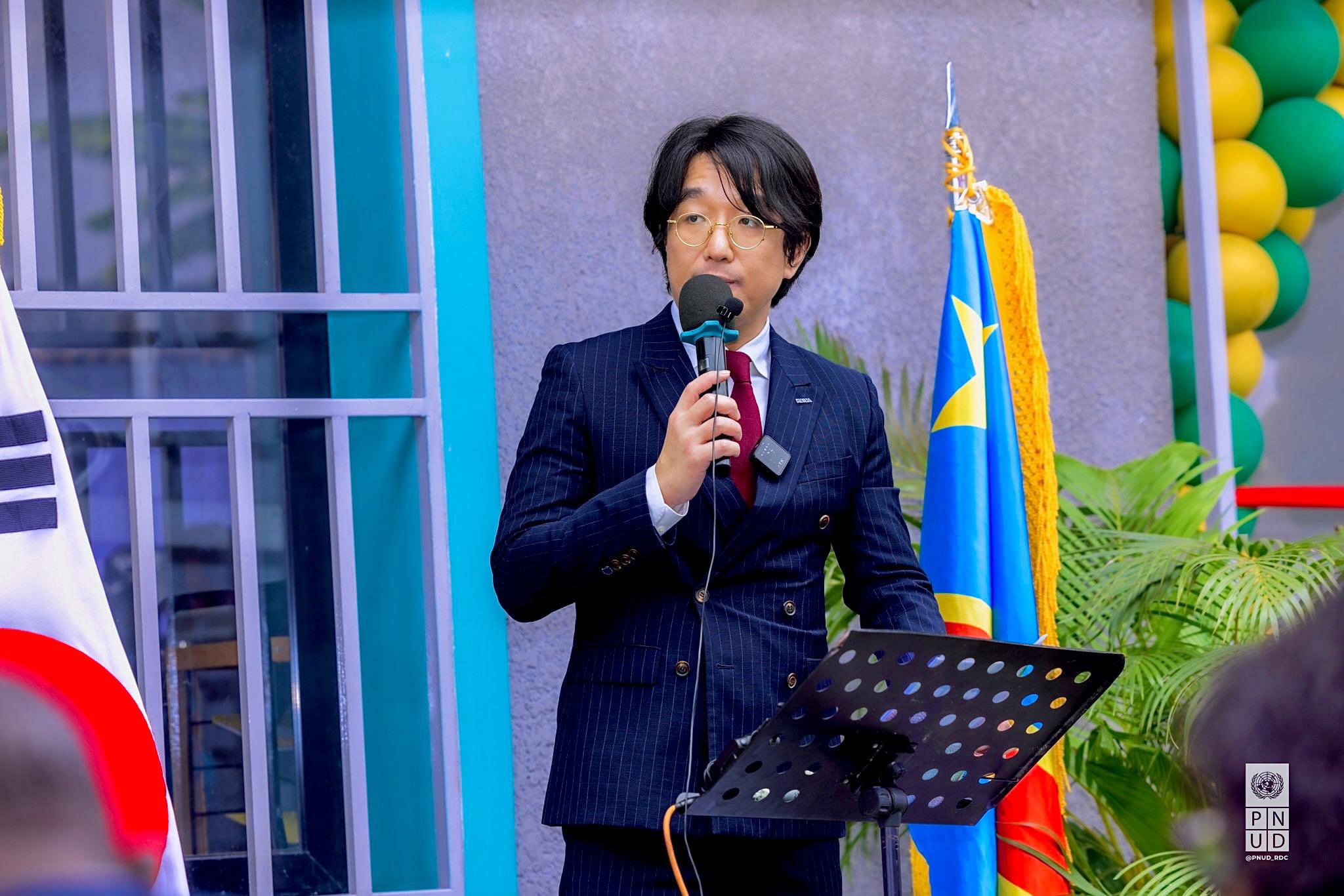 a man standing in front of a microphone