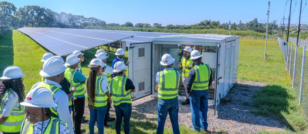 A group of people inspecting site of solar panels at the CEC's green bond