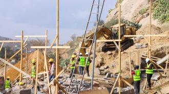 a group of people sitting at a construction site